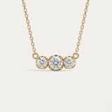 Front-facing view of the Everglow Trilogy Necklace in 18k yellow gold plating, featuring the 1.1ct graduated moissanite trio.