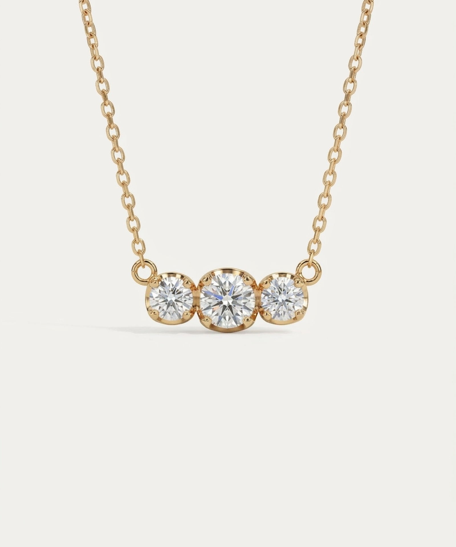 Front-facing view of the Everglow Trilogy Necklace in 18k yellow gold plating, featuring the 1.1ct graduated moissanite trio.