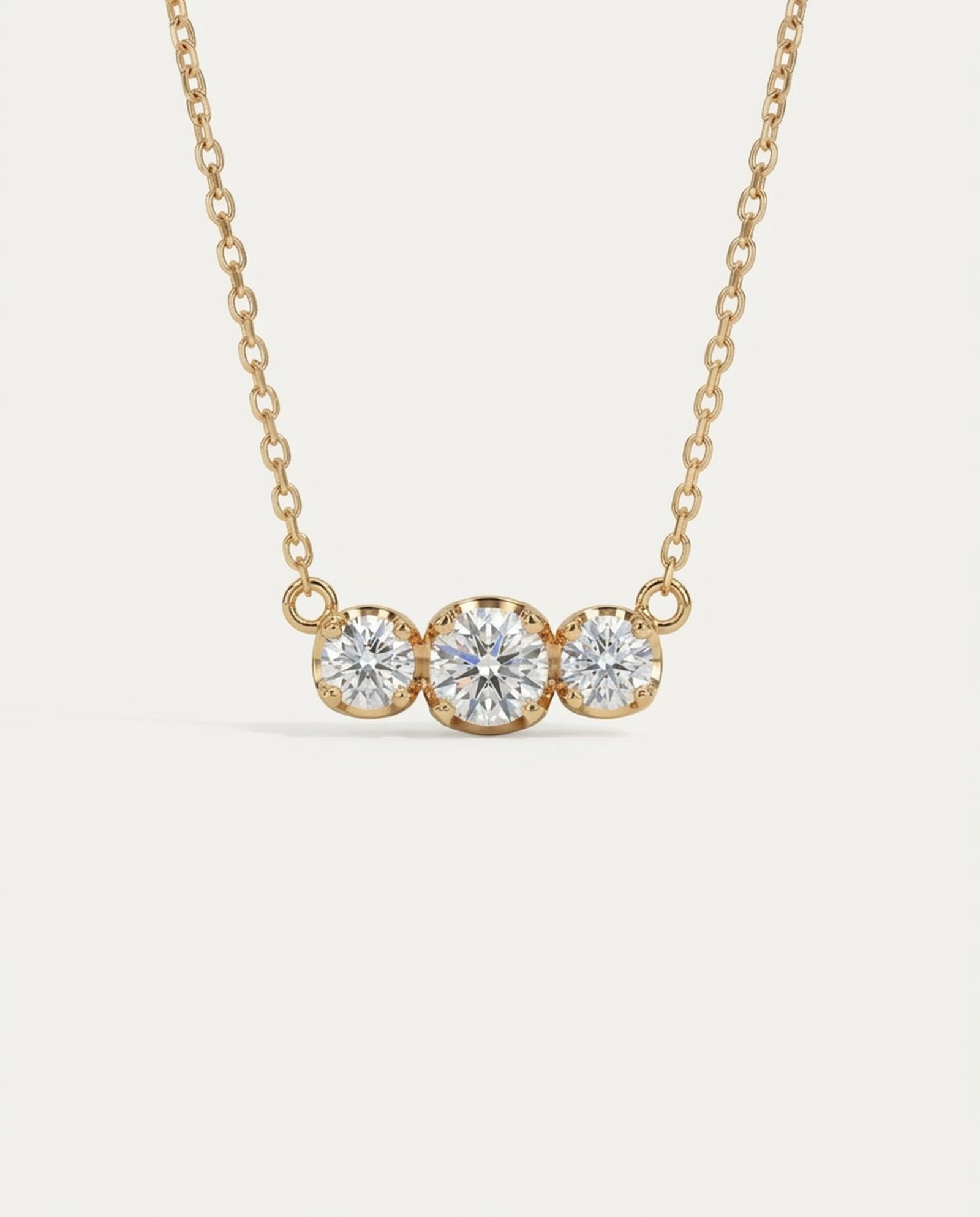 Front-facing view of the Everglow Trilogy Necklace in 18k yellow gold plating, featuring the 1.1ct graduated moissanite trio.