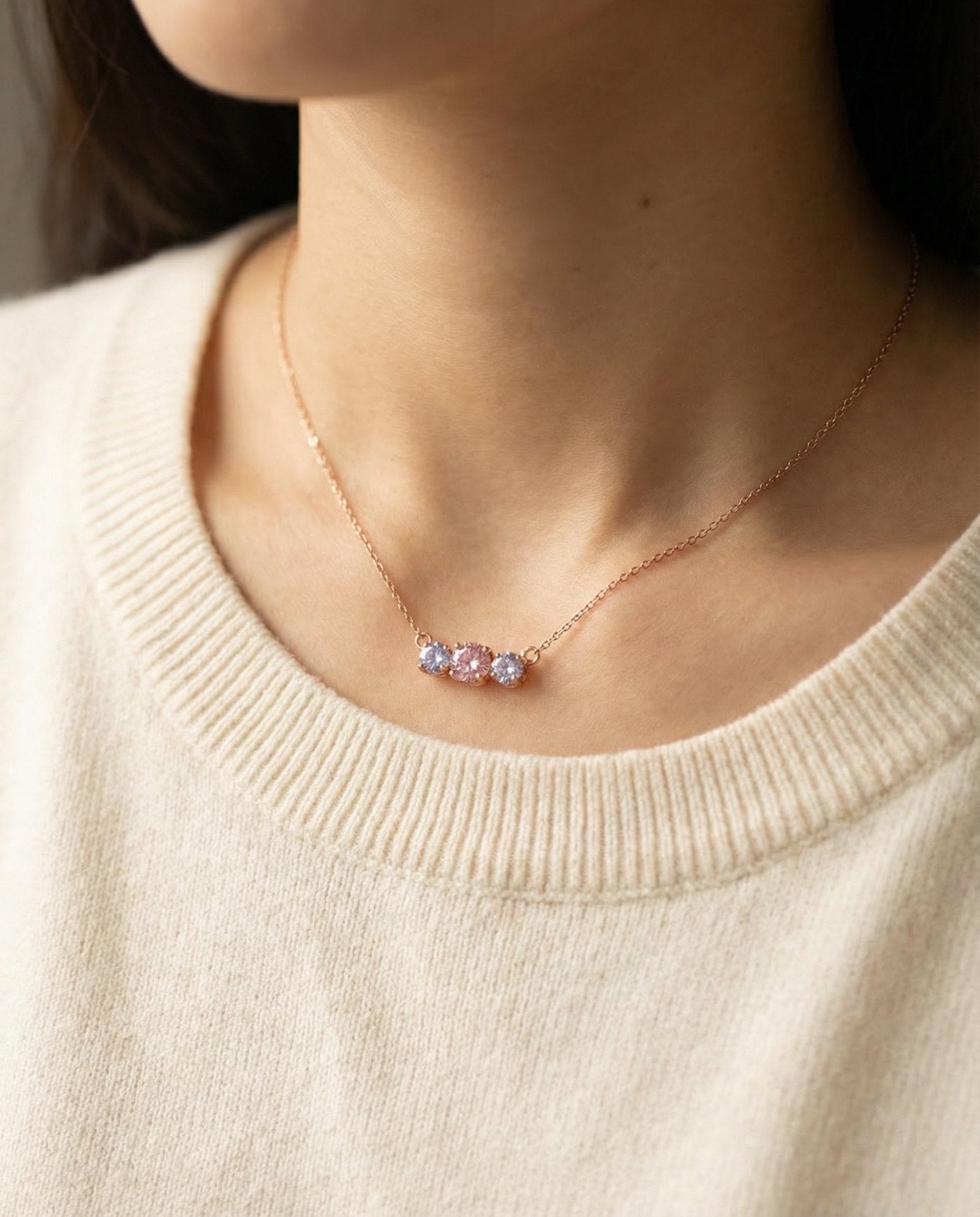 Model wearing the Rose Gold Everglow Trilogy Necklace, showing how the pink and lilac stones look against the skin.