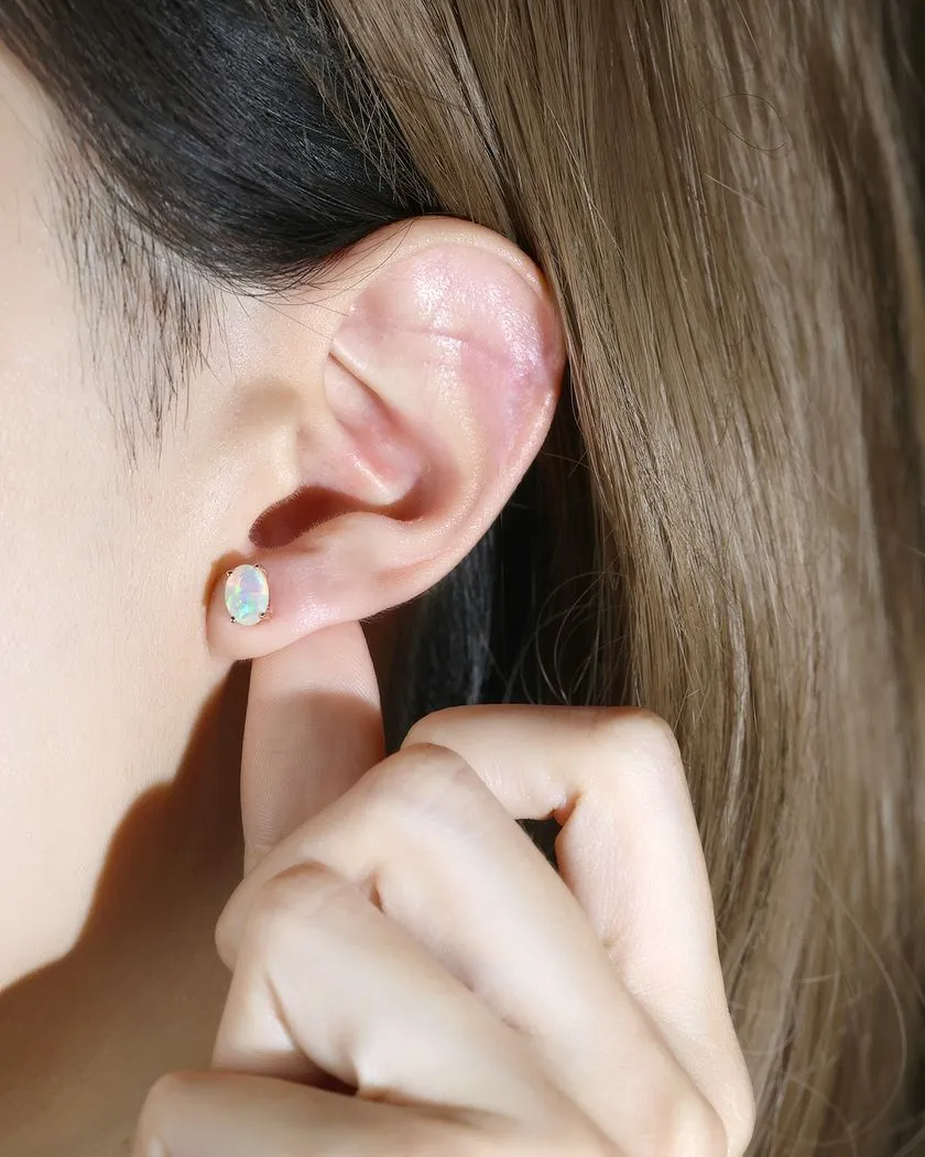 A model wearing the Prism Opal Studs in Rose Gold