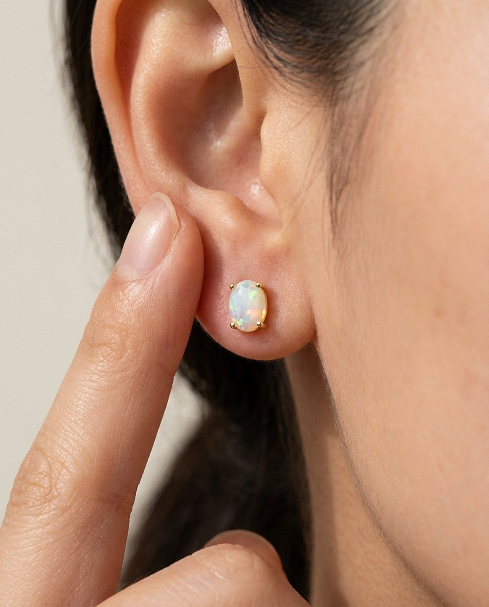 Prism Opal Studs in rose gold, worn on a model