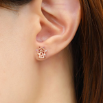 model wearing rose gold petite spinning ferris wheel studs in semi precious stones and moissanite