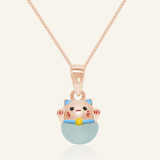 Fortune cat necklace featuring a rose gold pendant with a cheerful hand-painted cat perched atop a smooth blue chalcedony gemstone, symbolizing serenity and good fortune.