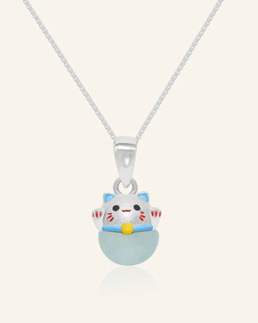 Fortune cat necklace featuring a silver pendant with a cheerful hand-painted cat perched atop a smooth blue chalcedony gemstone, symbolizing serenity and good fortune.