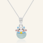 Fortune cat necklace featuring a silver pendant with a cheerful hand-painted cat perched atop a smooth blue chalcedony gemstone, symbolizing serenity and good fortune.