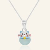 Fortune cat necklace featuring a silver pendant with a cheerful hand-painted cat perched atop a smooth blue chalcedony gemstone, symbolizing serenity and good fortune.