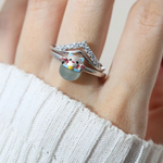 A model wearing the whimsical Fortune Cat ring crafted in silver, featuring a vibrant blue chalcedony gemstone. The adorable Maneki-neko design symbolizes luck and positivity, perfect for adding charm to any outfit.
