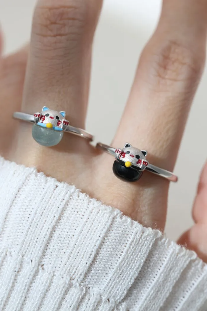 A model wearing the whimsical Fortune Cat ring crafted in silver, featuring a vibrant blue chalcedony gemstone. The adorable Maneki-neko design symbolizes luck and positivity, perfect for adding charm to any outfit.