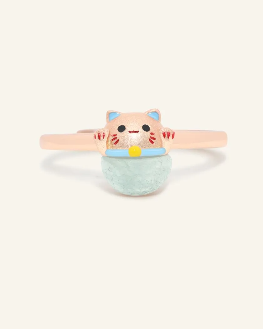 A whimsical Fortune Cat ring crafted in rose gold, featuring a vibrant blue chalcedony gemstone. The adorable Maneki-neko design symbolizes luck and positivity, perfect for adding charm to any outfit.