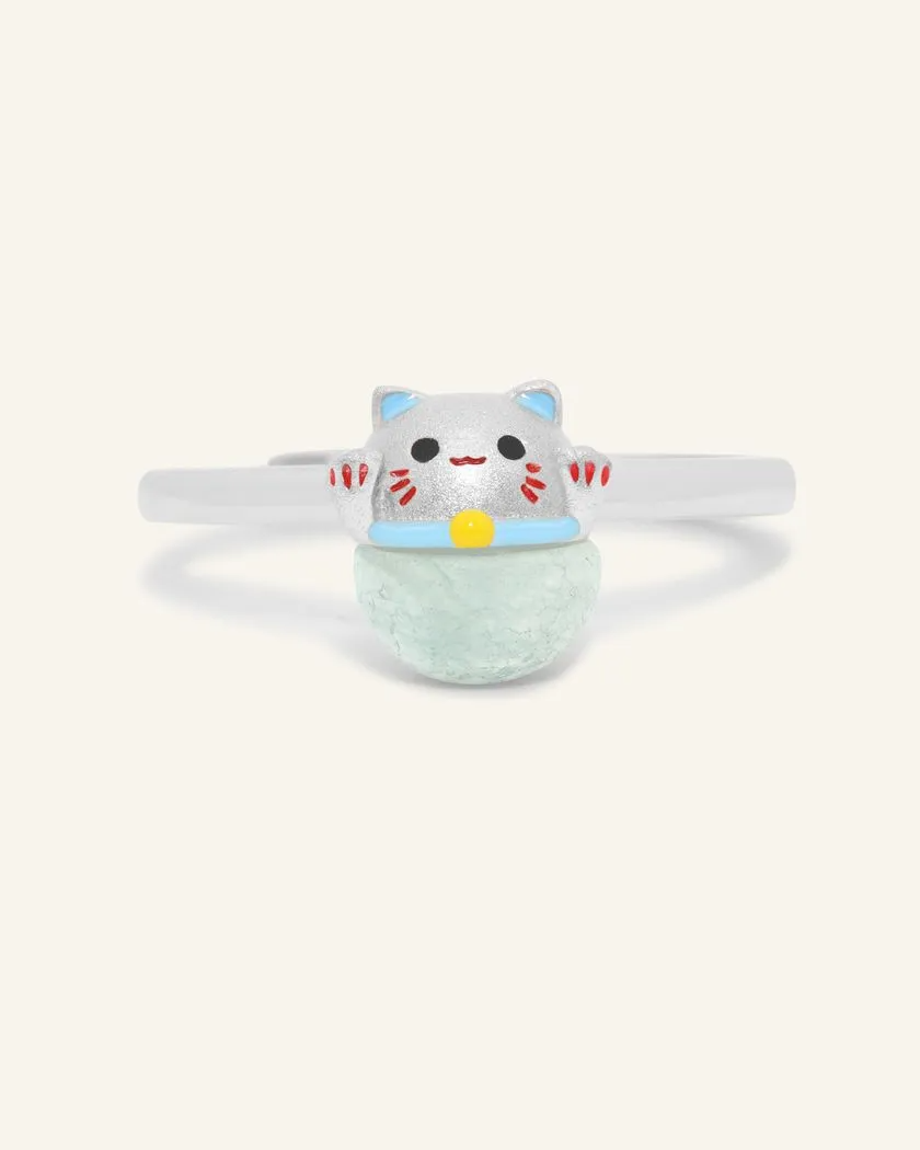 A whimsical Fortune Cat ring crafted in silver, featuring a vibrant blue chalcedony gemstone. The adorable Maneki-neko design symbolizes luck and positivity, perfect for adding charm to any outfit.