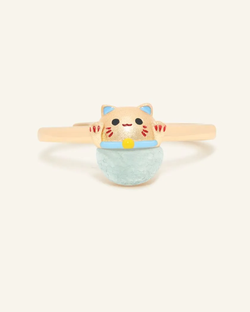A whimsical Fortune Cat ring crafted in yellow gold, featuring a vibrant blue chalcedony gemstone. The adorable Maneki-neko design symbolizes luck and positivity, perfect for adding charm to any outfit.