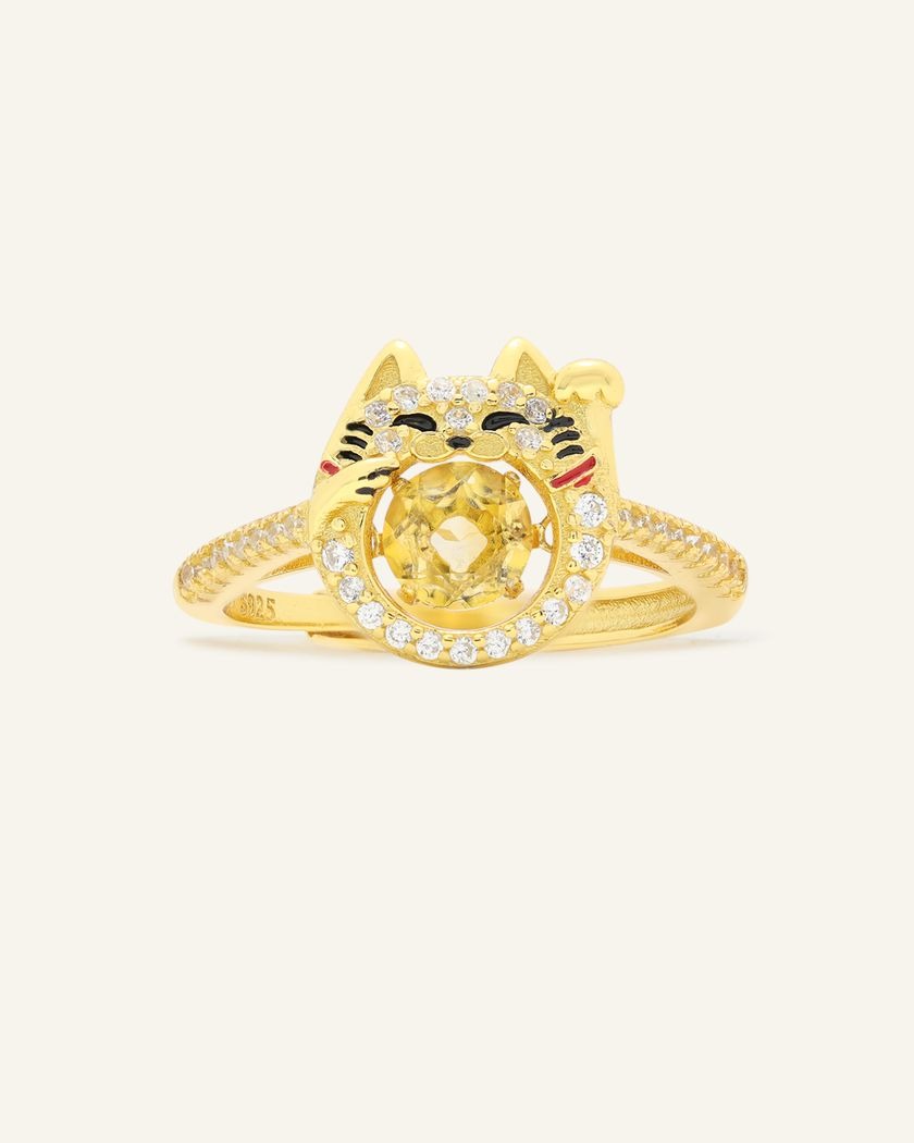 Fortune cat-inspired ring featuring a vibrant citrine gemstone at its center, adorned with shimmering pavé accents and playful enamel details, crafted in yellow gold.