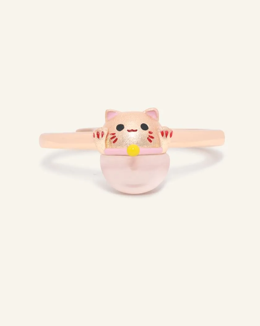 Fortune cat ring crafted in rose gold, featuring a playful cat motif resting on a polished rose quartz gemstone, symbolizing luck and positivity.