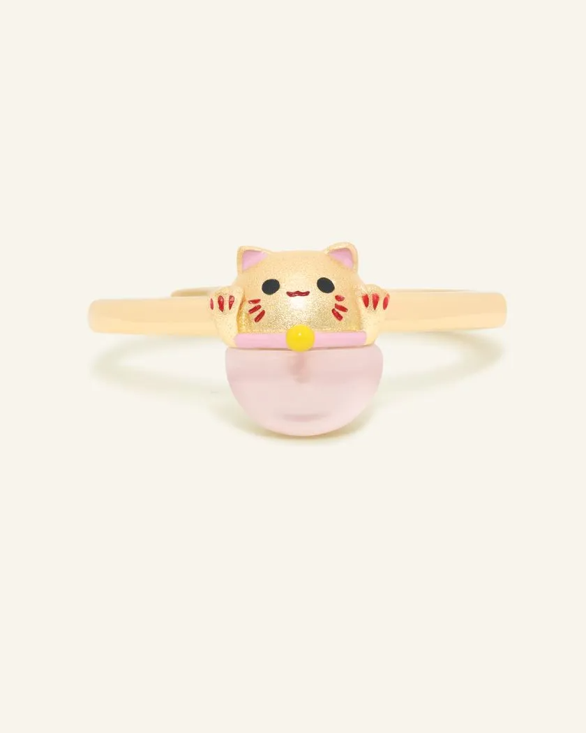 Fortune cat ring crafted in yellow gold, featuring a playful cat motif resting on a polished rose quartz gemstone, symbolizing luck and positivity.