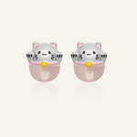 Silver fortune cat-inspired studs featuring adorable feline motifs perched on delicate rose quartz gemstones, symbolizing love and positivity.