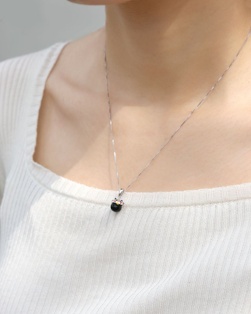Fortune Cat Necklace (Obsidian) in silver, worn on a model