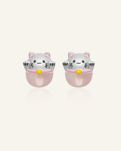 Fortune Cat Studs (Rose Quartz) in silver, resting on a warm linen background