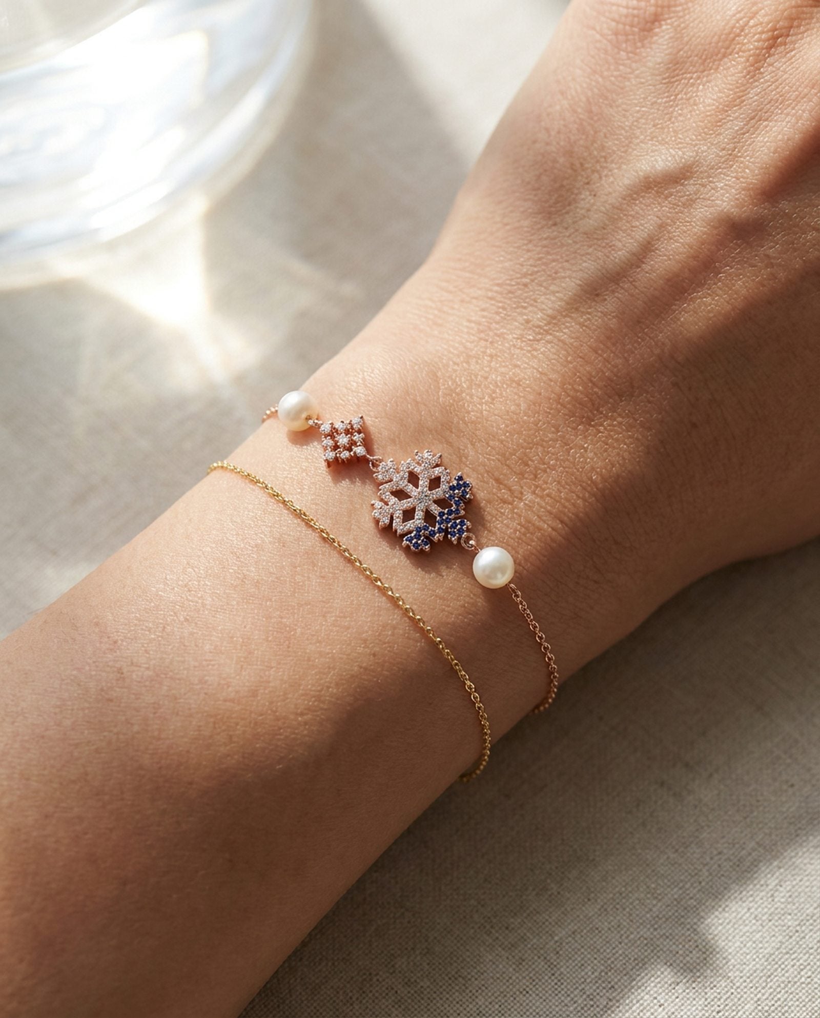 Frosted Snowflake Pearl Bracelet in rose gold, worn on a model