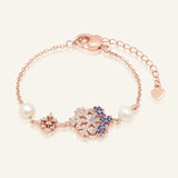 Close-up of the Frosted Snowflake Pearl Bracelet in rose gold, resting on a warm linen background