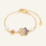 Frosted Snowflake Pearl Bracelet in yellow gold, resting on a warm linen background