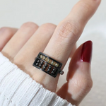 A model wearing the Golden Beads Abacus Ring in black gold