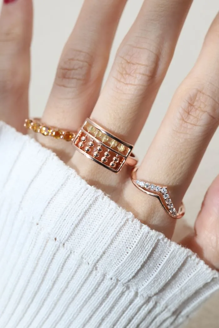 A model wearing the Golden Beads Abacus Ring in rose gold