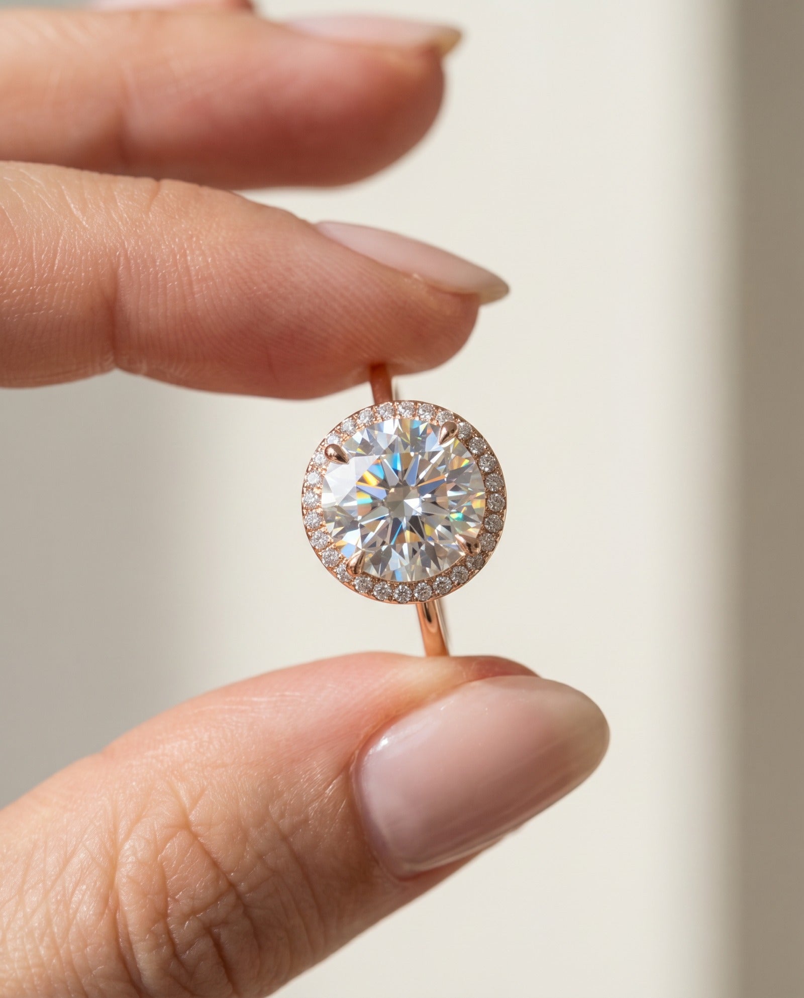 Side angle of the Grand Halo Ring in Rose Gold, demonstrating the classic raised setting and substantial 9mm moissanite depth.