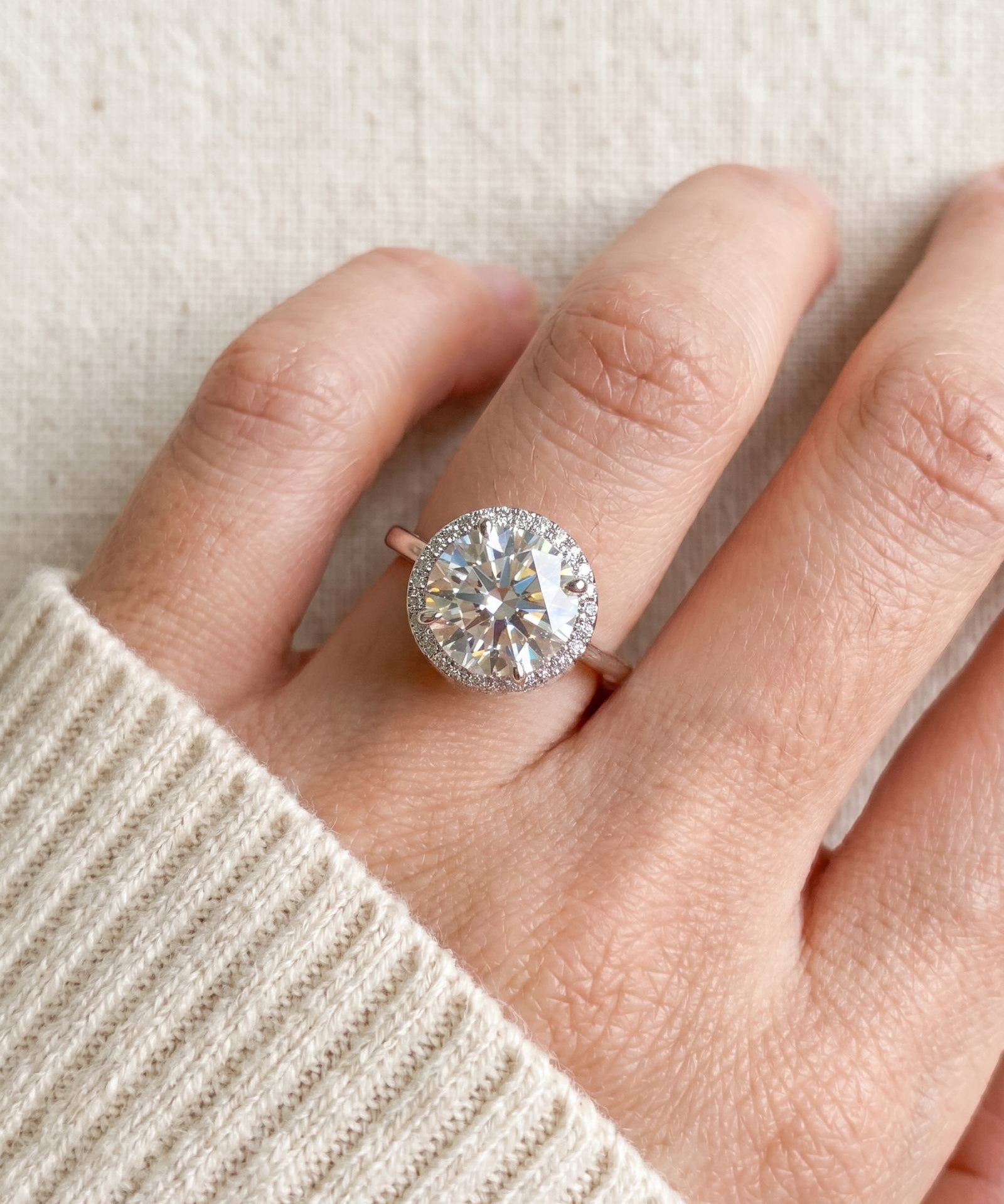 Top-down scale view of Grand Halo Ring in Silver worn on a finger, highlighting the massive 11mm total halo silhouette.