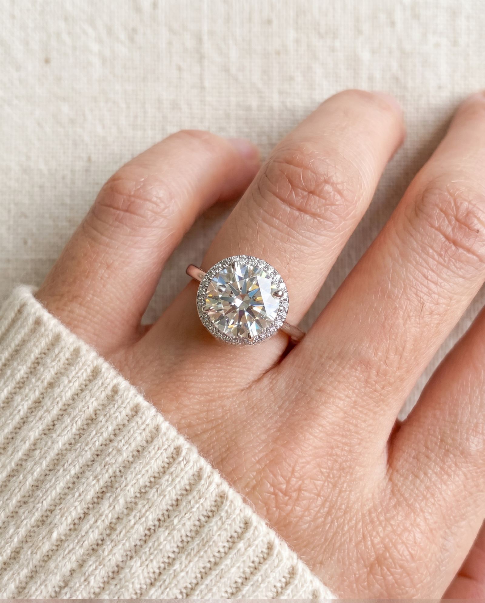 Top-down scale view of Grand Halo Ring in Silver worn on a finger, highlighting the massive 11mm total halo silhouette.