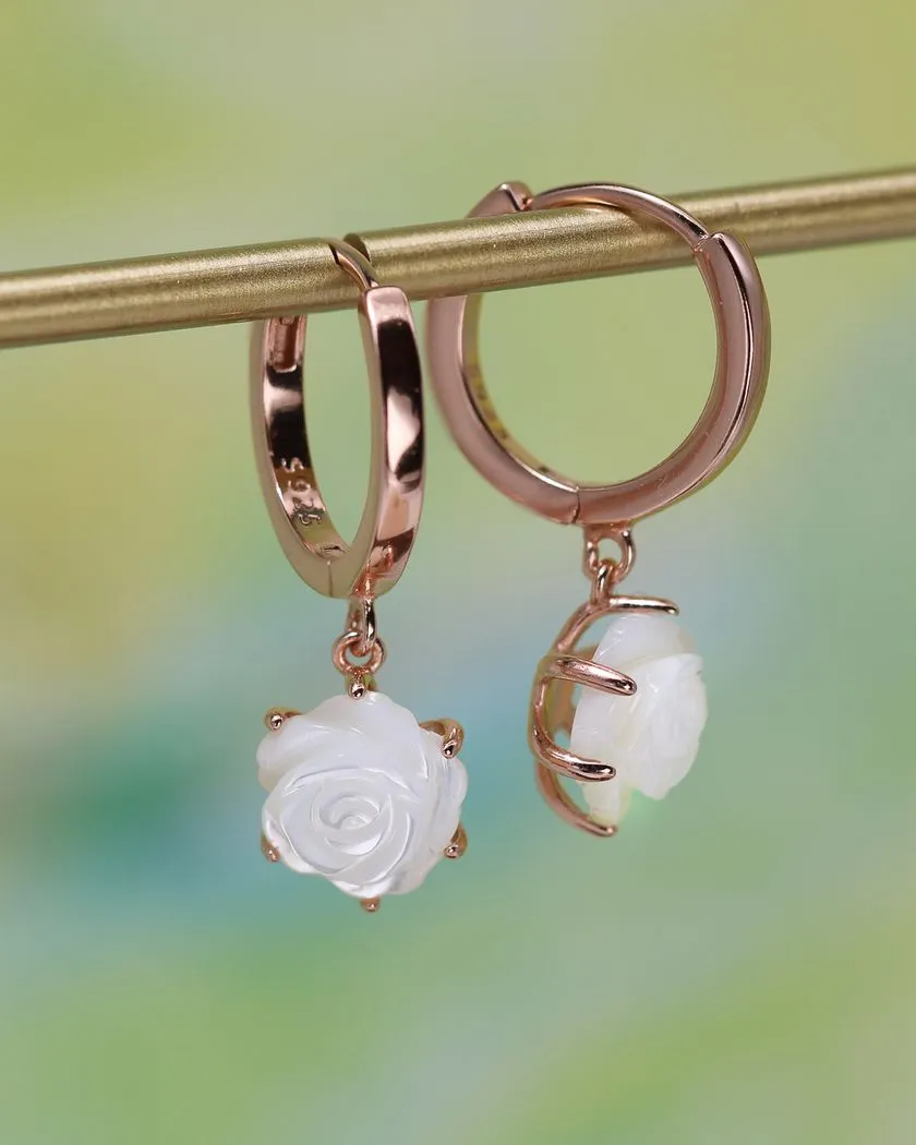 Handcarved White Shell Rose Huggies in Rose Gold – Elegant and delicate huggie earrings featuring intricately carved white shell roses, set in a secure rose gold prong setting, perfect for a timeless and romantic look.