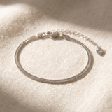 Herringbone Bracelet | Elate in silver, laid flat on a tabletop