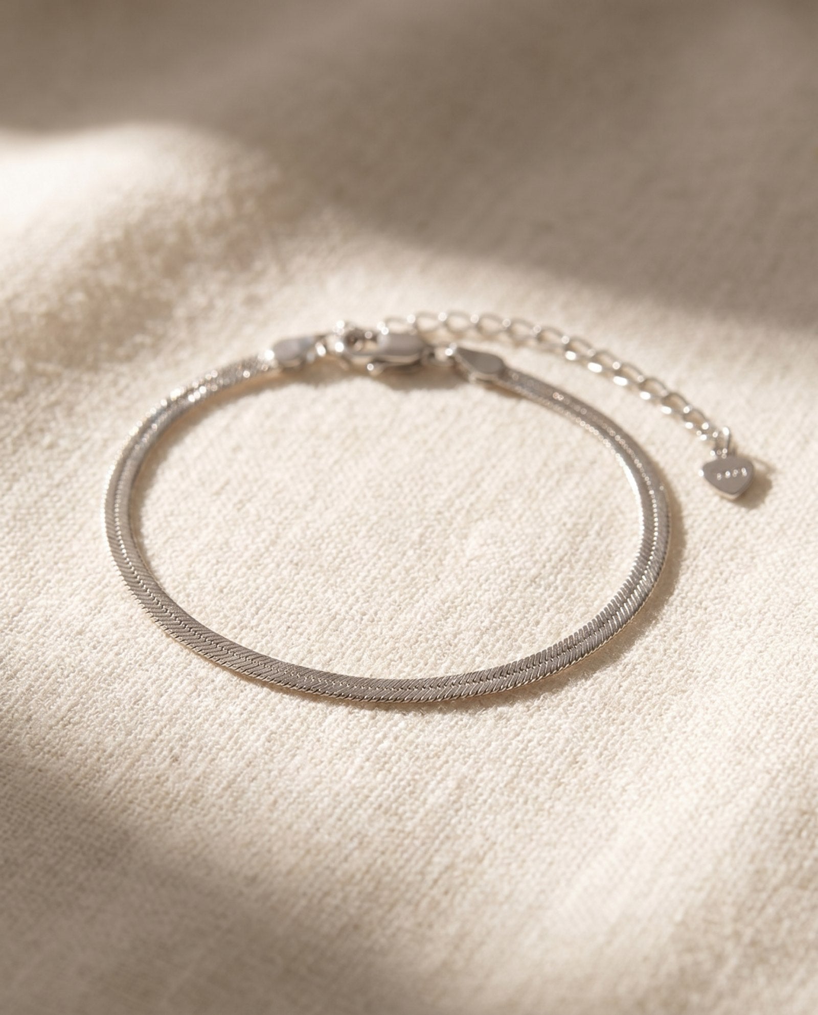 Herringbone Bracelet | Elate in silver, laid flat on a tabletop