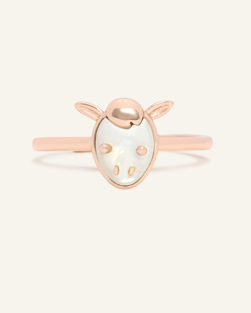 A delicate rose gold ring featuring a mother of pearl centerpiece shaped like a horse's head.