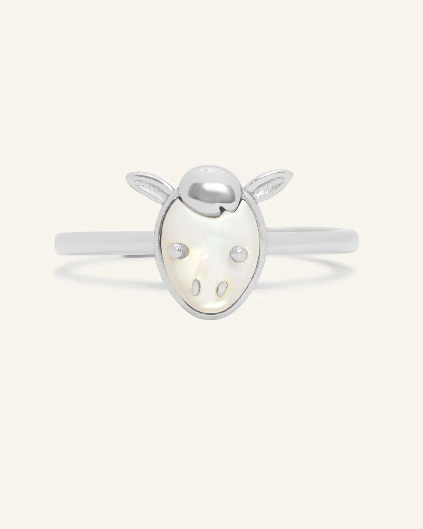 A delicate silver ring featuring a mother of pearl centerpiece shaped like a horse's head.