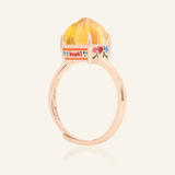 Rose gold Huat Kueh-inspired ring featuring a vibrant citrine gemstone as the steamed cake centerpiece, adorned with intricate enamel details, including 'Huat' and floral accents symbolizing prosperity and joy.