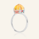 Silver Huat Kueh-inspired ring featuring a vibrant citrine gemstone as the steamed cake centerpiece, adorned with intricate enamel details, including 'Huat' and floral accents symbolizing prosperity and joy.