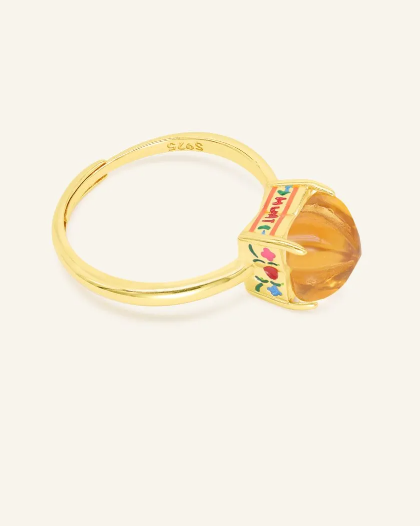 Yellow Gold Huat Kueh-inspired ring featuring a vibrant citrine gemstone as the steamed cake centerpiece, adorned with intricate enamel details, including 'Huat' and floral accents symbolizing prosperity and joy.