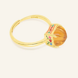 Yellow Gold Huat Kueh-inspired ring featuring a vibrant citrine gemstone as the steamed cake centerpiece, adorned with intricate enamel details, including 'Huat' and floral accents symbolizing prosperity and joy.