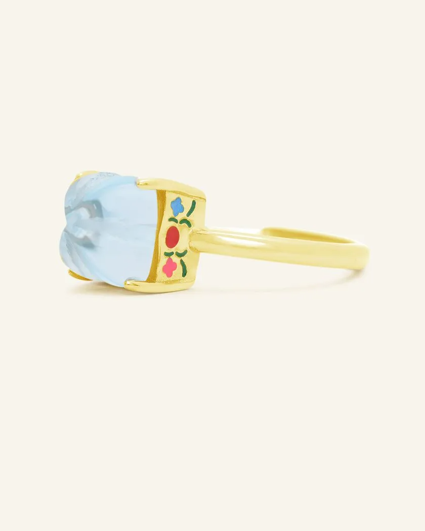 Yellow Gold Huat Kueh-inspired ring featuring a vibrant sky blue topaz gemstone as the steamed cake centerpiece, adorned with intricate hand-painted enamel details, including 'Huat' and floral accents symbolizing prosperity and joy.