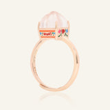 Close-up of the Huat Kueh Ring (Rose Quartz) in rose gold, resting on a warm linen background