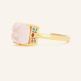 Huat Kueh Ring (Rose Quartz) in yellow gold, resting on a warm linen background, alternate angle