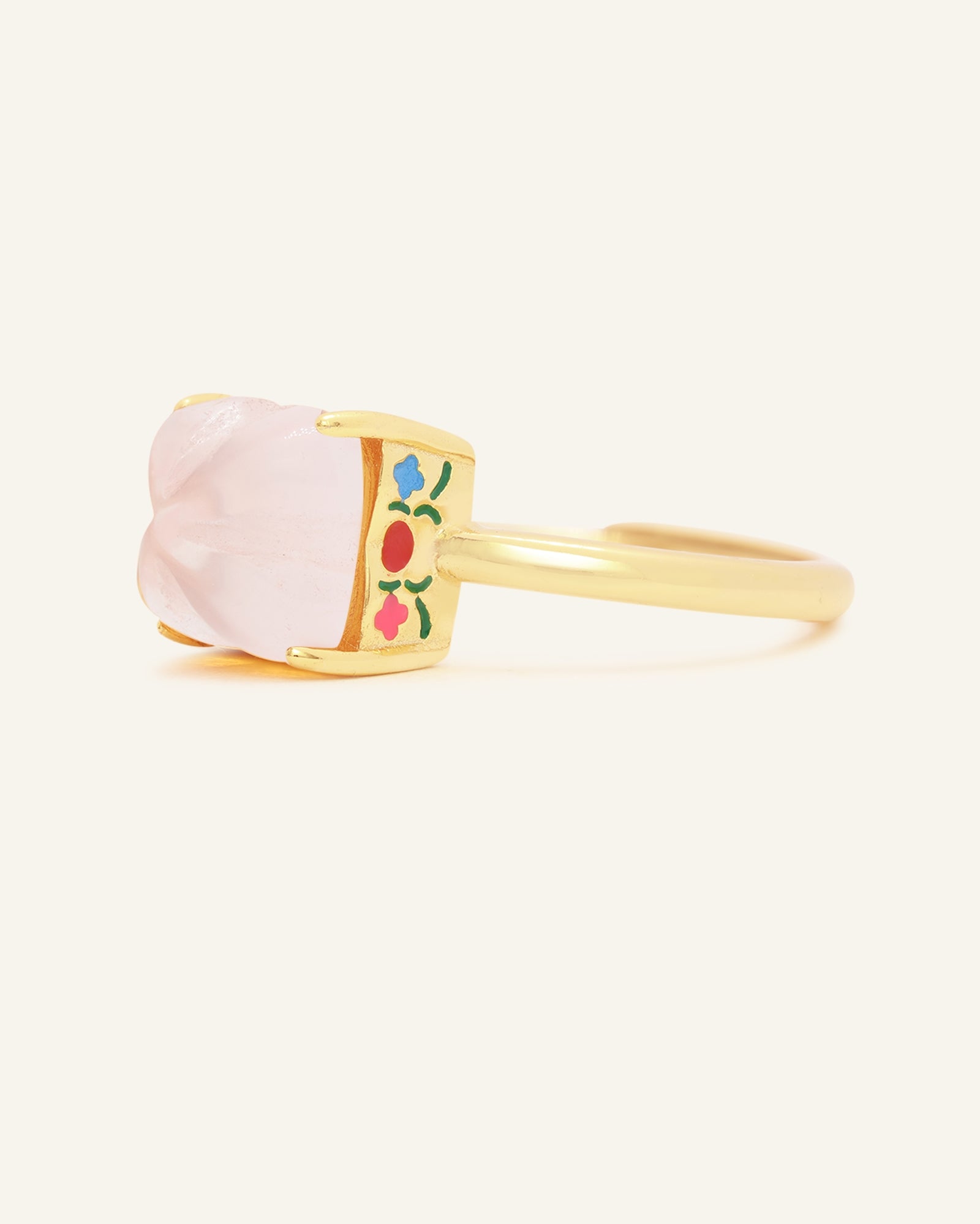 Huat Kueh Ring (Rose Quartz) in yellow gold, resting on a warm linen background, alternate angle