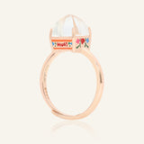 Close-up of the Huat Kueh Ring (White Topaz) in rose gold, resting on a warm linen background