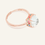 Huat Kueh Ring (White Topaz) in rose gold, resting on a warm linen background, alternate angle
