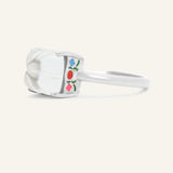 Huat Kueh Ring (White Topaz) in silver, resting on a warm linen background