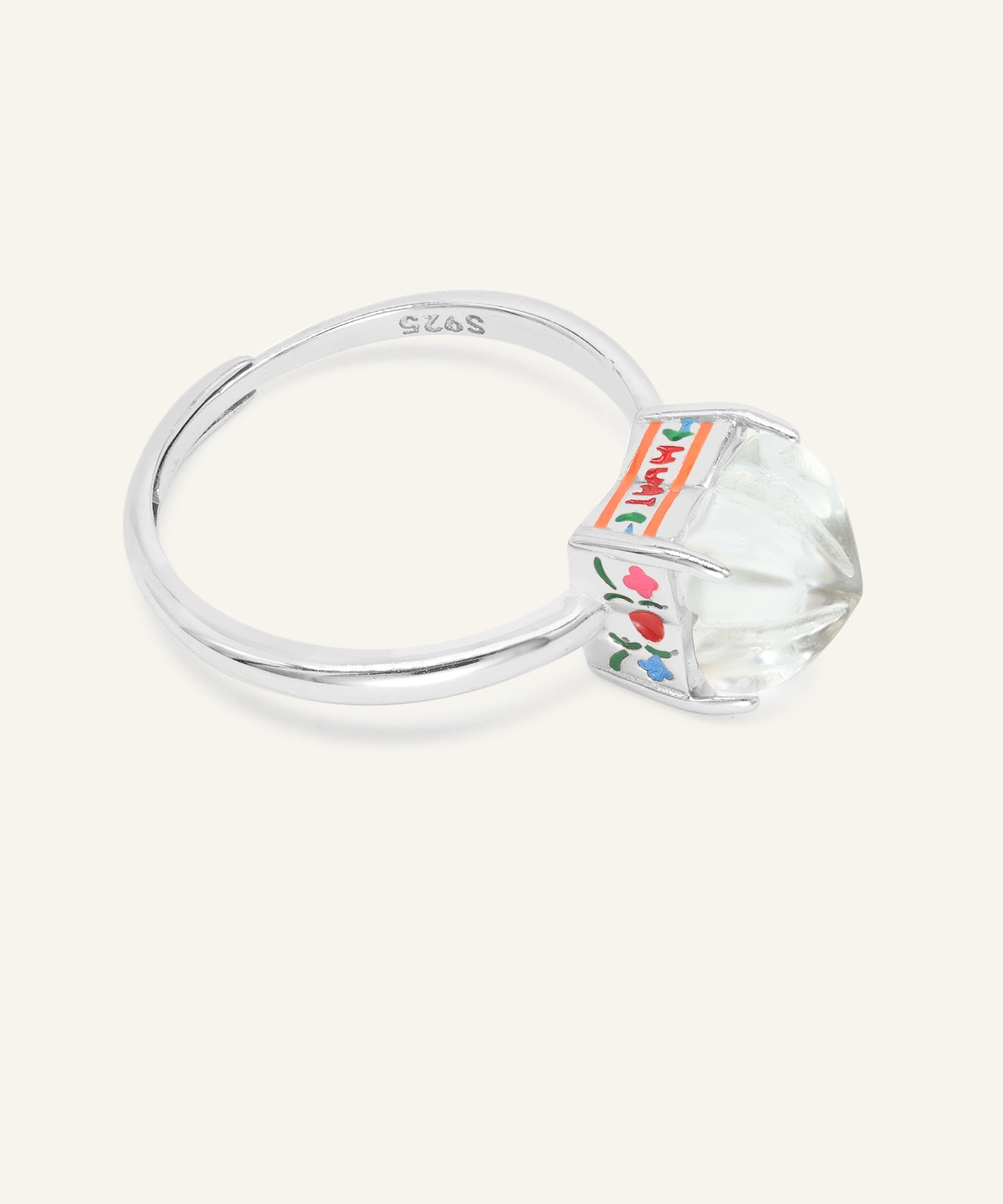 Huat Kueh Ring (White Topaz) in silver, resting on a warm linen background, alternate angle