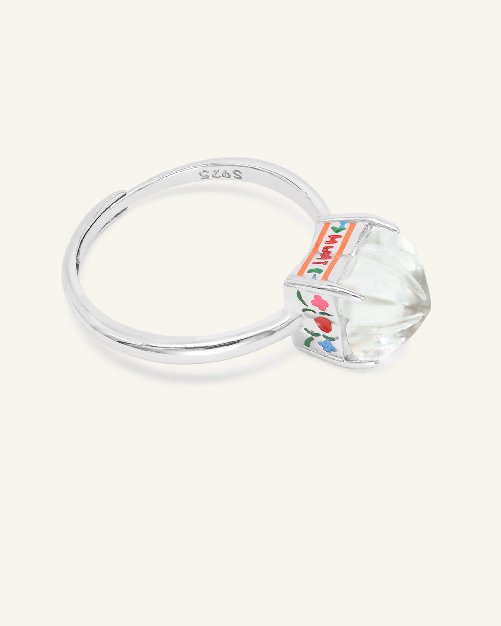 Huat Kueh Ring (White Topaz) in silver, resting on a warm linen background, alternate angle