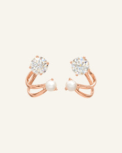 Illusion Ear Jackets | Moissanite & Pearl, Elate in rose gold, resting on a warm linen background