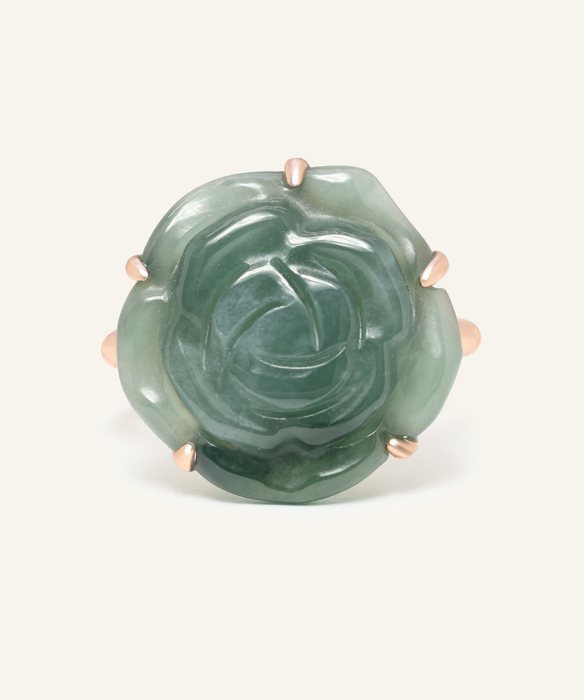 Close-up of the Jadeite Rose Ring in rose gold, resting on a warm linen background